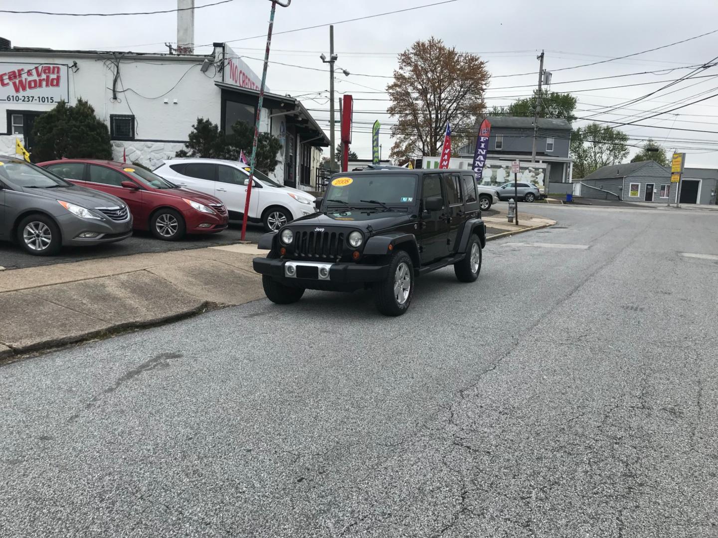 2008 Black /Black Jeep Wrangler Unlimited Sahara 4WD (1J8GA59198L) with an 3.8L V6 OHV 12V engine, Automatic transmission, located at 577 Chester Pike, Prospect Park, PA, 19076, (610) 237-1015, 39.886154, -75.302338 - Photo#1